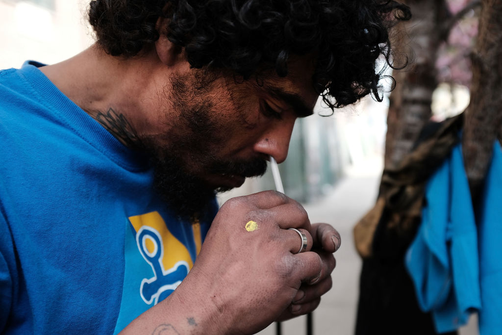 Eliezer, a 38 year old homeless heroin addict, snorts heroin in the Bronx on May 4, 2018 in New York City. Eliezer often snorts his heroin instead of injecting as he feels it lessens the chances of overdosing on the drug. (Spencer Platt/Getty Images)