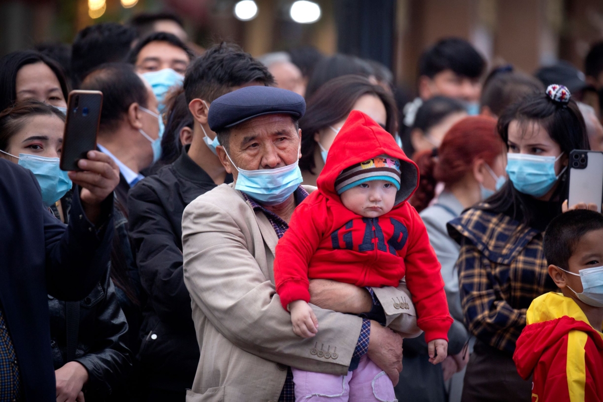 man holds a child in Xinjiang 
